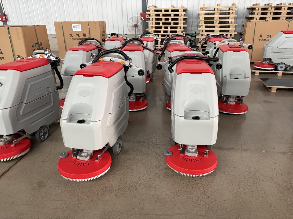Actual GODWIN GDW1 walk-behind scrubbers in the company product photo
